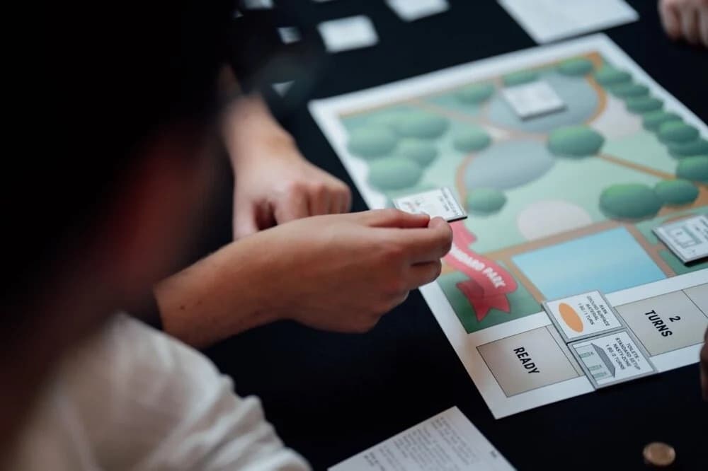 Participant placing a card on the Standard Park game board