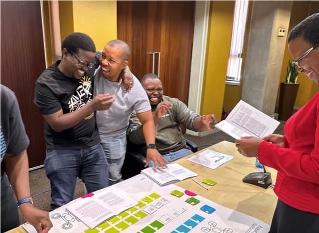 Participants celebrating during a Patent Quest game session