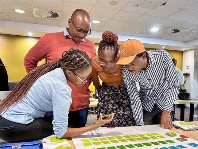 Participants gathered around the Patent Quest game board during play