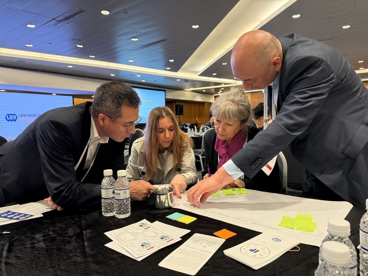 Participants collaborating around the Serious LESI Game: Uncharted IP Waters at a conference table